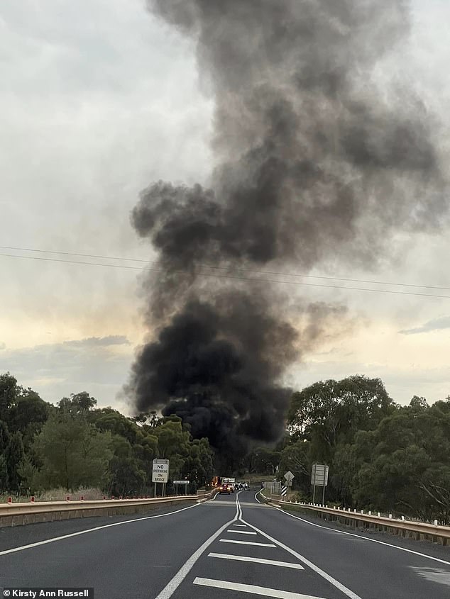 Thick black smoke rose from the highway where the SUV and truck collided