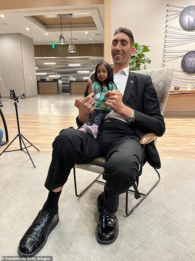 Sultan Kosen, who is 8 feet tall, and Jyoti Amge, who is just 21 feet tall, made a striking couple as they posed for photos in Irvine, California yesterday.