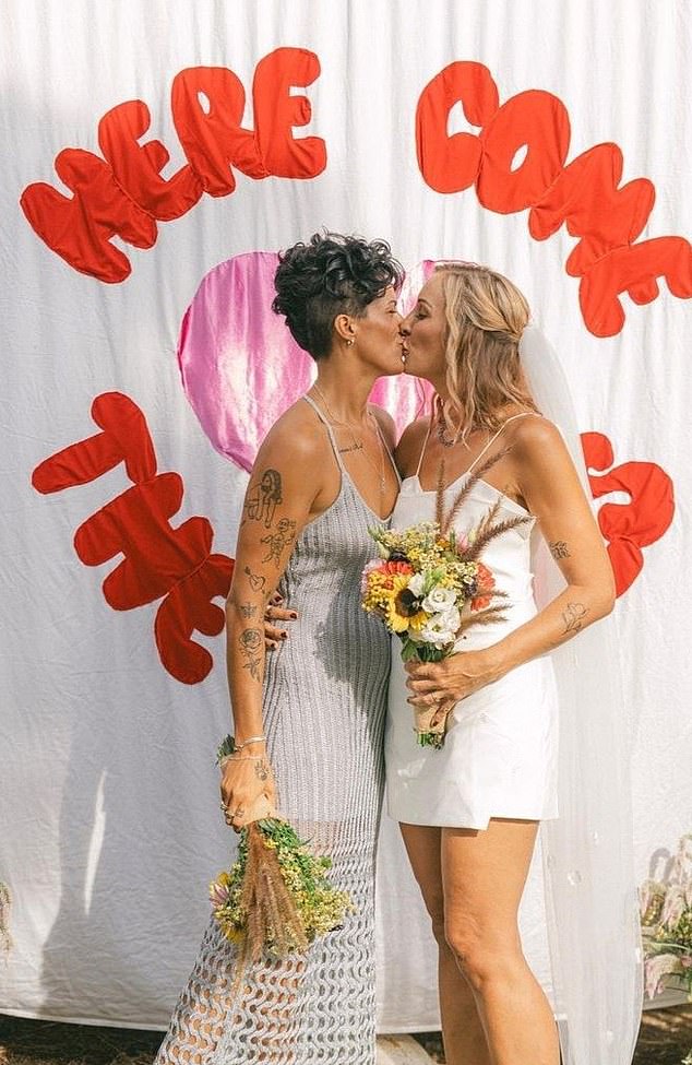 Ellen exchanged vows with her boyfriend and sealed their union with a kiss in front of a beautiful handmade party banner that read 'Here Come The Brides'