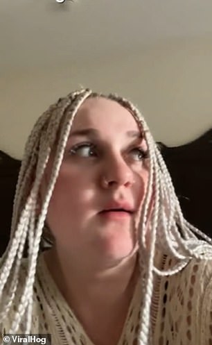 The tourist, who has white dreadlocks and nose piercings, makes his first appearance in the video waiting for one of the monkeys on the balcony to enter the hotel room