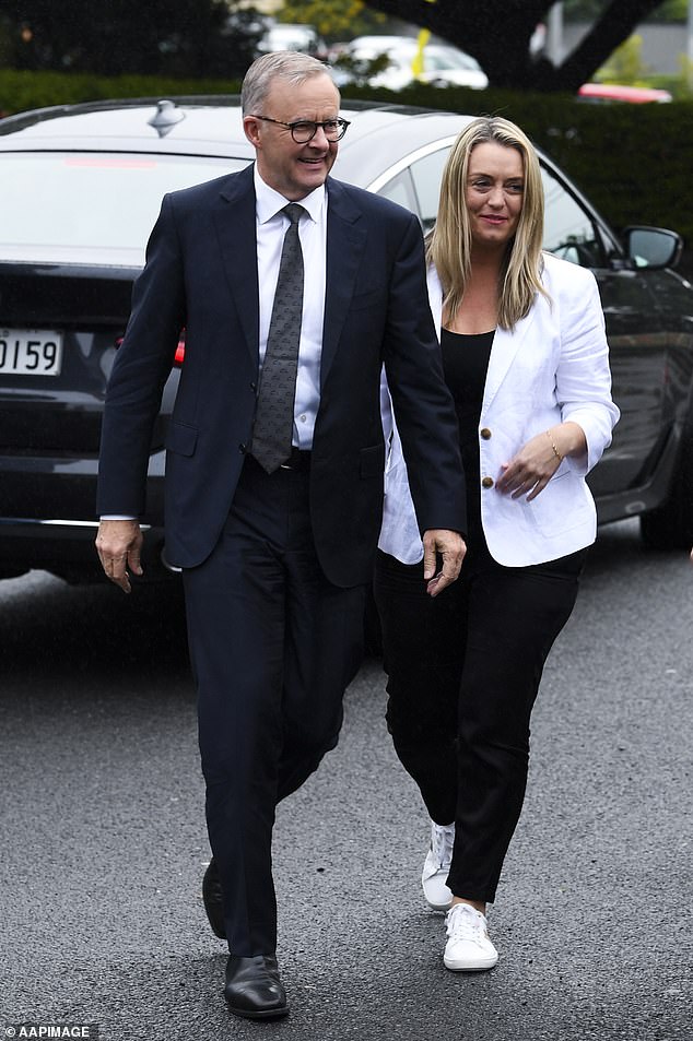 Senior officials worked on the government's 'broken promise', the third phase of tax cuts, in December, while Anthony Albanese (pictured with his partner Jodie Haydone) said he had 'no plans' to make changes