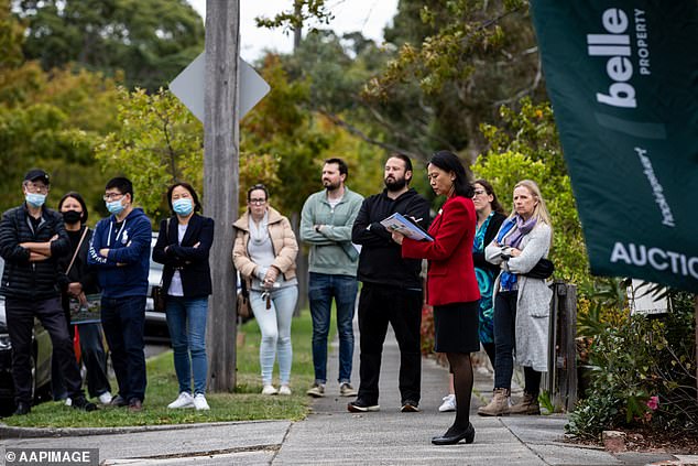 The average new Australian mortgage has risen to a record high of $624,383, even as the Reserve Bank has hiked rates 13 times in 18 months (pictured is an auction in Melbourne)