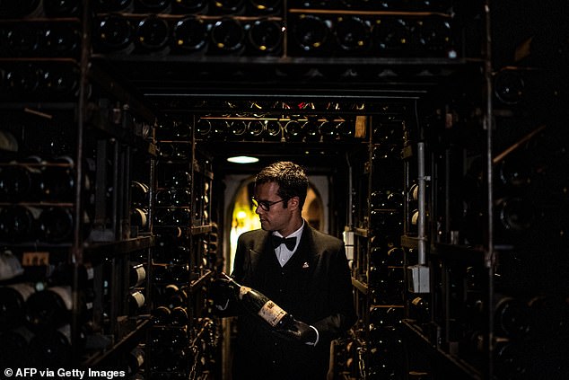 A sommelier in the basement of the Parisian restaurant, which has 27 rooms with more than 300,000 bottles worth a combined £21 million