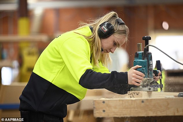 Women could be encouraged to take up apprenticeships as Australia faces a serious shortage of construction traditions (pictured is Melbourne stair maker Paige Hunter)