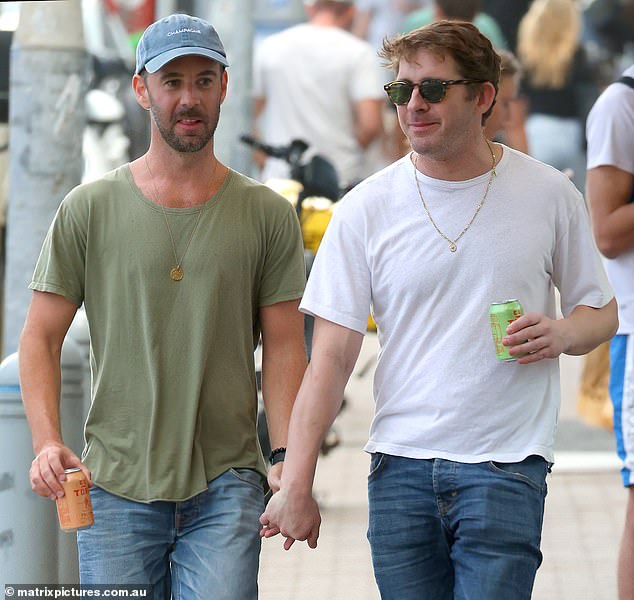 Hugh Sheridan was spotted holding hands while enjoying an alcoholic drink with a mystery man in Sydney's Bondi on Monday.  Both shown