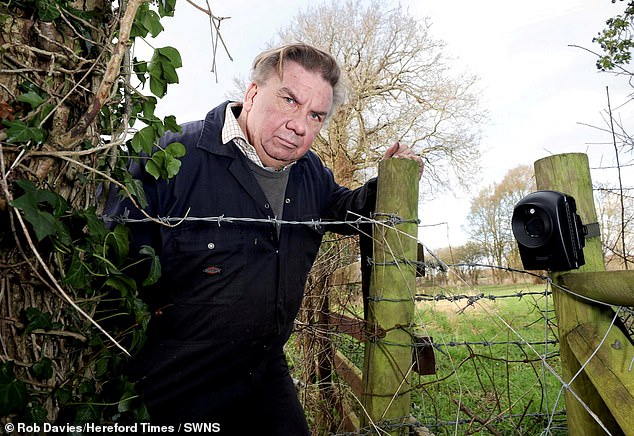 Martin Prior, 65, with the CCTV camera he discovered pointed at his property.  Prior fears the camera is being used by a convicted pedophile to film his grandson