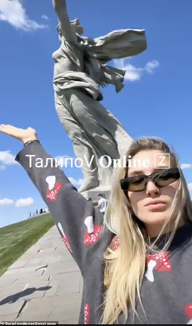 Agafonova posed under the statue.  She was placed on Russia's wanted list and detained this week when she returned to her home country