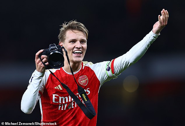 Martin Odegaard celebrated Arsenal's 3-1 win over Liverpool on Sunday by borrowing a photographer's camera and taking several pictures of the cameraman with home supporters