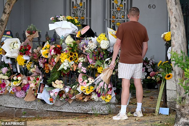 A sea of ​​flowers have been left at the house where police allege TV presenter Jesse Baird and his air hostess partner Luke Davies were murdered (pictured)