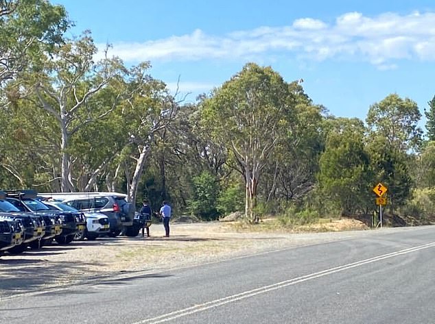 Their bodies are said to have been buried under a pile of earth (photo, right of the police officer) along a road in Bungonia.  Police are said to have unknowingly driven past the bodies several times earlier this week during a search of another building about 20 minutes to the south.
