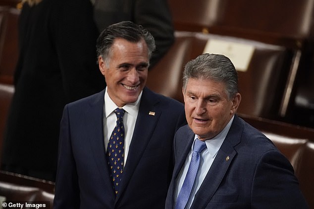 Pictured: Moderate Senator Mitt Romney (left) and Joe Manchin (right) speak on the floor of the House of Representatives during President Joe Biden's State of the Union address to Congress on March 1, 2022