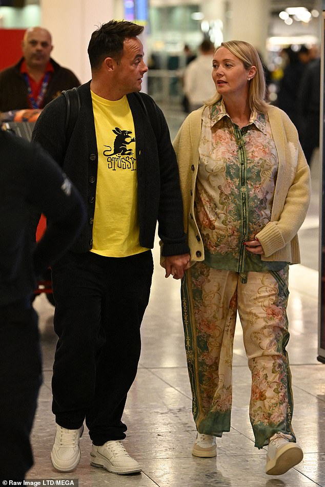 Baby bump: Ant with Anne Marie at Heathrow Airport last month - The photo that broke Lisa's heart