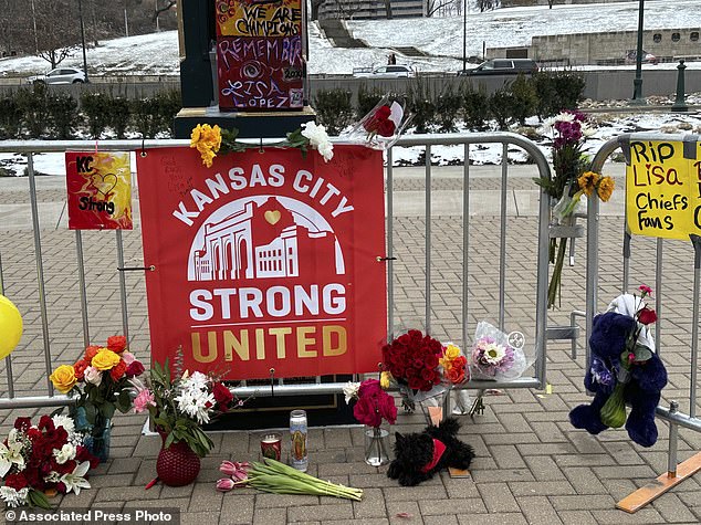 Flowers, signs and other items are collected in front of Union Station, the site of the shooting