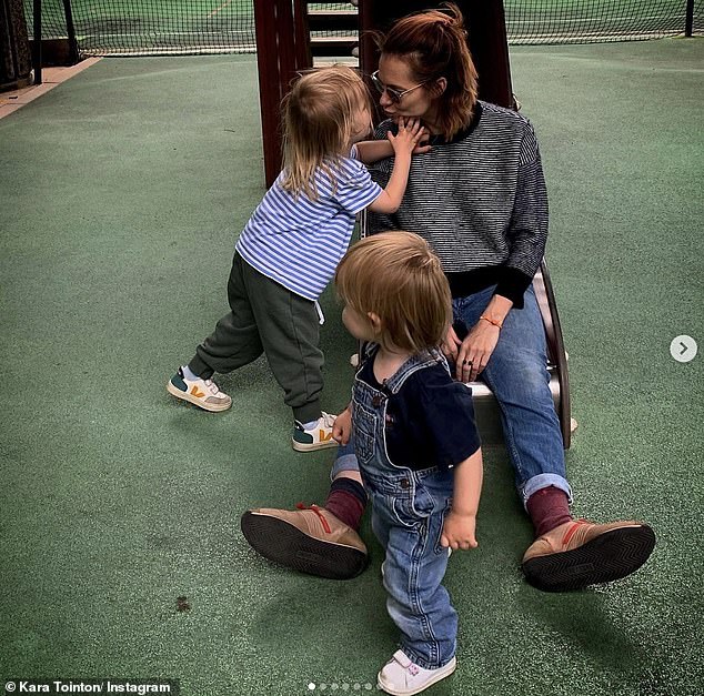 The actress, 40, said becoming a mother means she has less time to maintain her youthful looks, but said it was 'very grounding' because 'you only have one focus' (pictured with her sons)