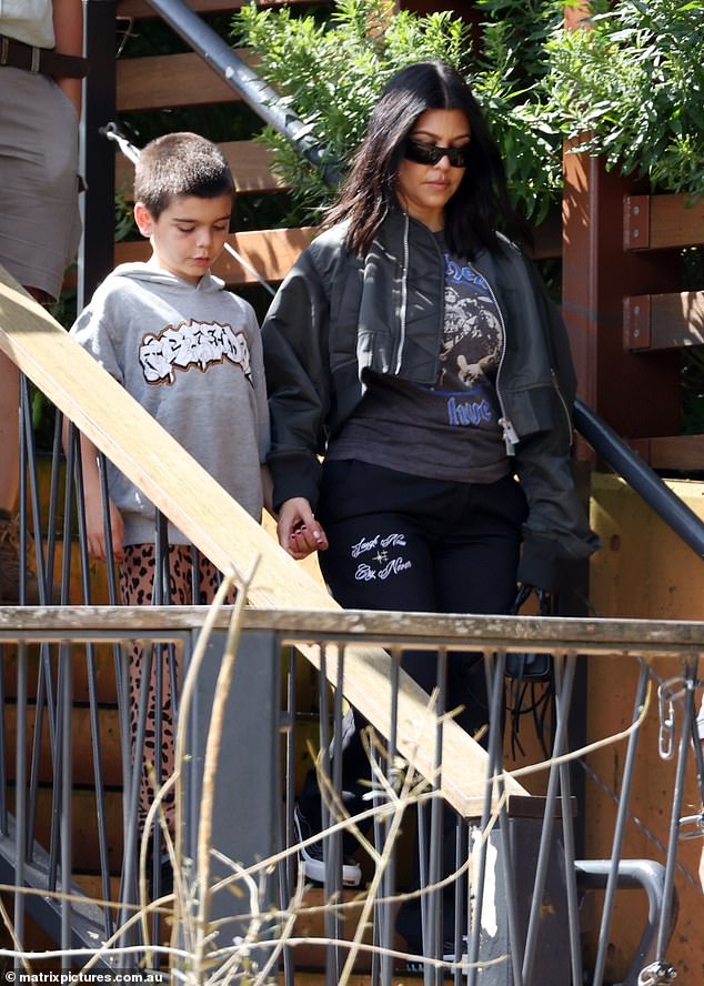 Kourtney Kardashian and her son Reign had a personal encounter with a giraffe during a fun trip to the Taronga Zoo in Sydney, Australia, on Thursday.