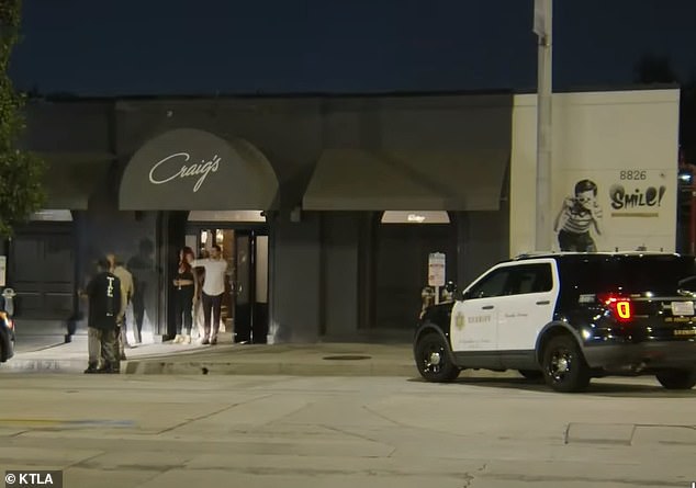 A robbery took place outside Craig's - 'one of LA's most celebrity restaurants' - under investigation on Thursday.  Pictured: Police outside Craig's in West Hollywood