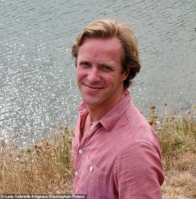 Lady Gabriella this evening released a personal photo she took of her husband, showing him smiling, wearing a casual pink shirt, as he stood by a stretch of water in the sun.