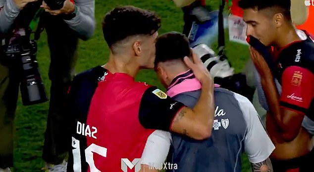 Messi is kissed on the head by a Newell's player after the 1-1 draw at the DRV PNK Stadium