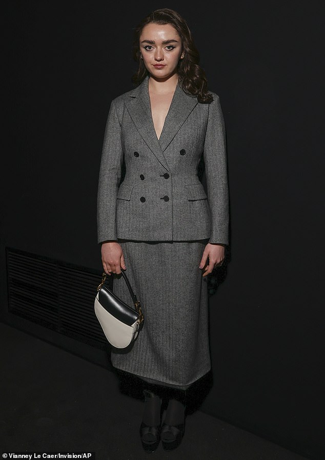 Maisie Williams, 26, cut an elegant figure in a gray double-breasted suit at a Christian Dior runway show in Paris on Tuesday