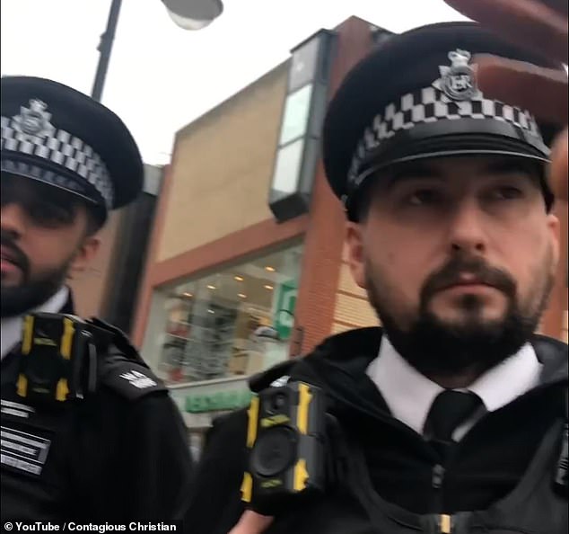 The footage starts with the preacher explaining to the officers what they were preaching