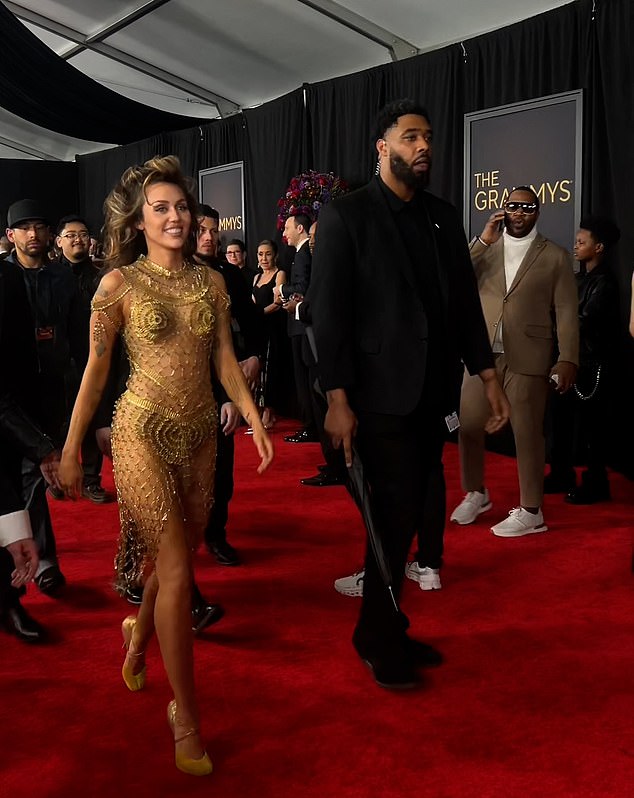 Social media sleuths have sparked wild theories about Miley Cyrus' security details after her red carpet walk at the Grammys