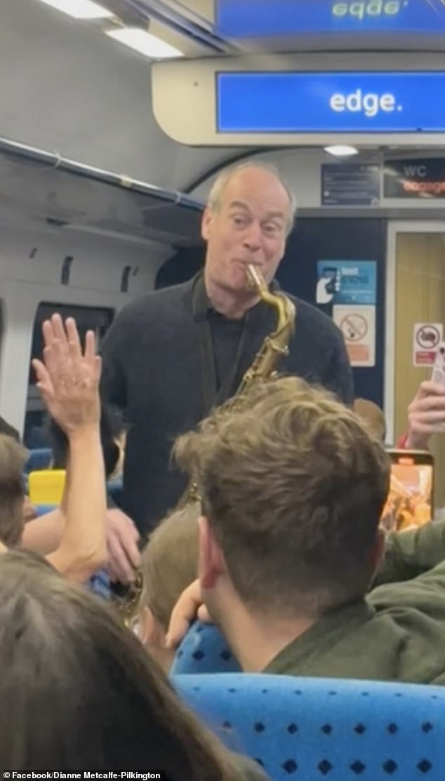 Brendan Duffy (standing) boarded the last train from Leeds to Harrogate on Friday and was asked to 'play a tune' by the other commuters after they saw his instrument case