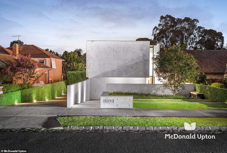 The monolithic facade of a spectacular house contrasts with the adjacent historic cottages on Essendon Street, 8km north of Melbourne's CBD