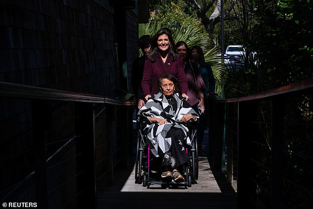 Republican presidential candidate Nikki Haley pushes her mother Raj to their polling place on Kiawah Island, South Carolina, on Saturday to vote in the Republican Party's primary, where she is the final rival against front-runner, former President Donald Trump