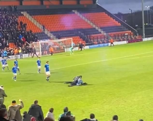 A National League match descended into chaos on Saturday when a pitch intruder struck a steward