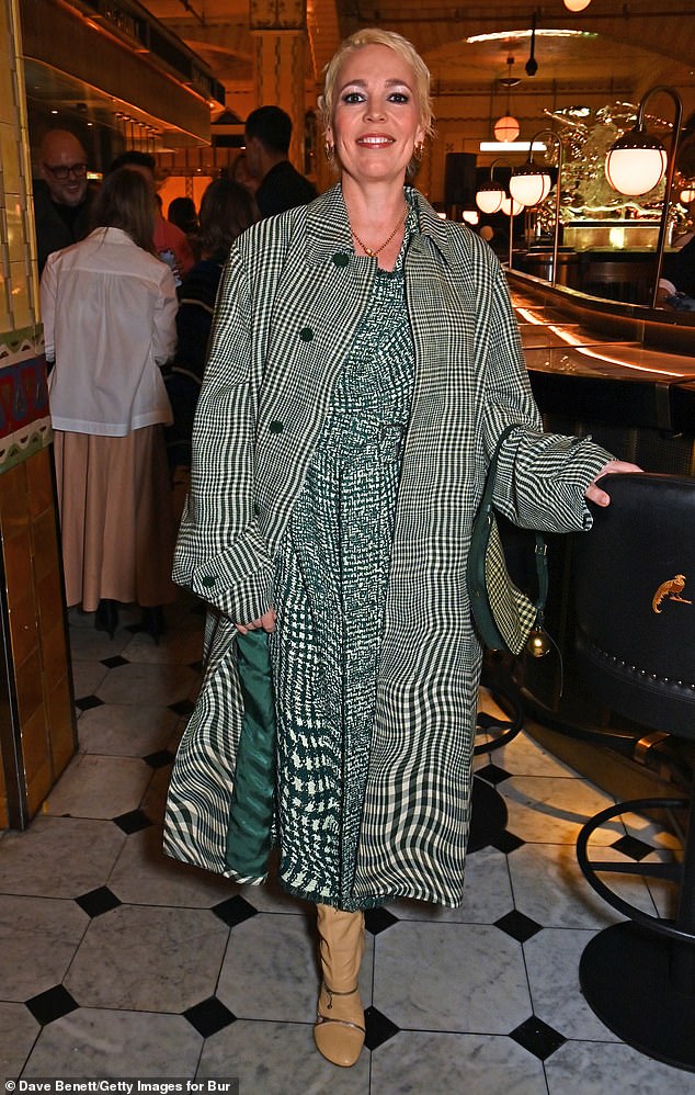 She turned heads in a green and white checked trench coat that she wore over a matching dress