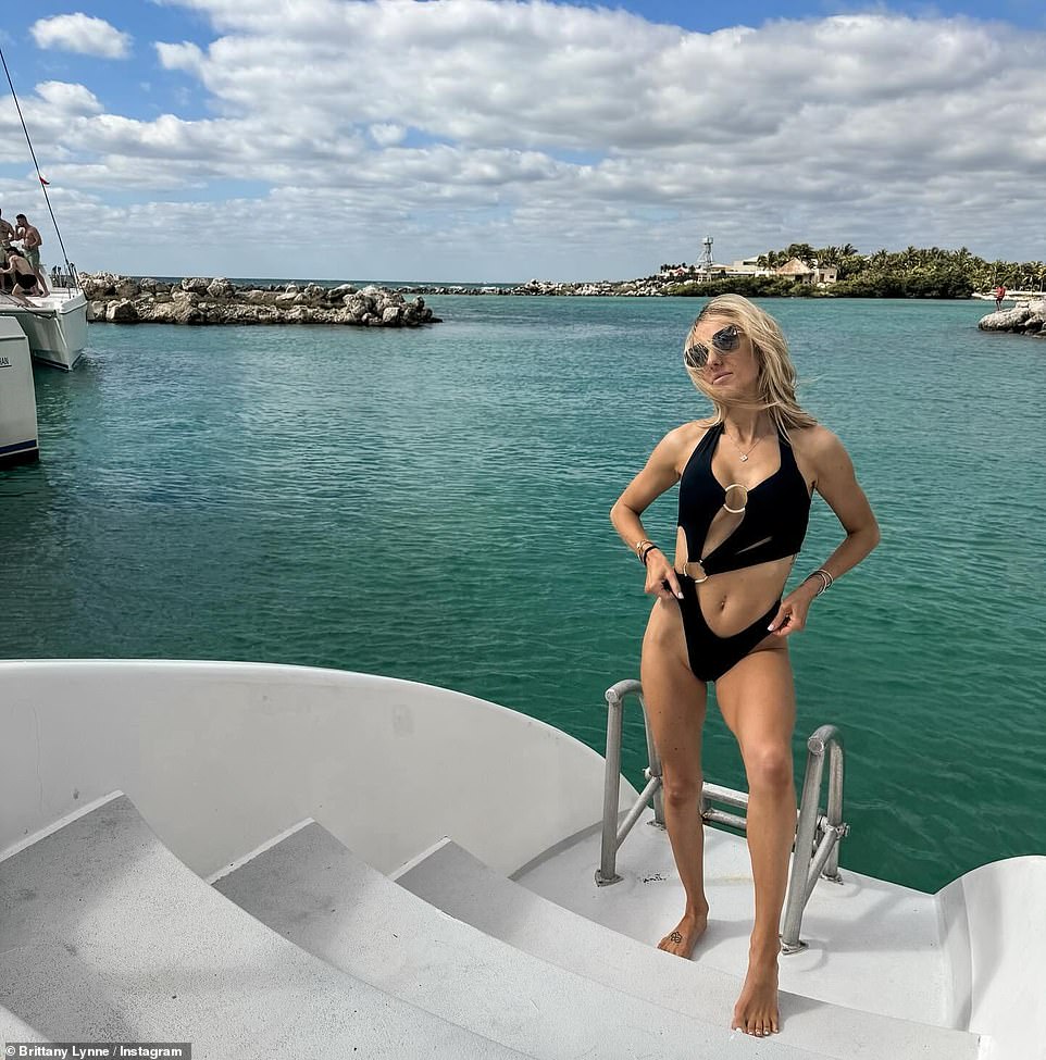 Brittany Mahomes showed off her very toned and slim body on Sunday in a black strappy monokini with a gold ring accent