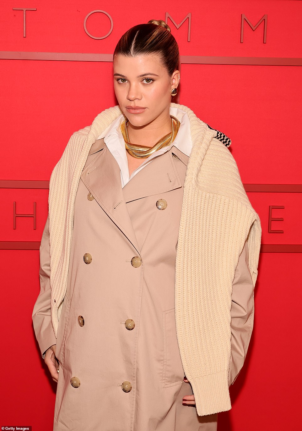 The label's new brand ambassador, Sofia, 25, cradled her baby bump in a chic brown trench coat