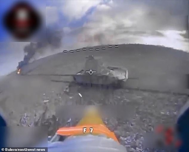 A still image from a video recorded with a drone-mounted camera shows the moment before the UAV crashed into a Russian armored vehicle that was part of a column of eleven Putin's war machines that were destroyed in a Ukrainian drone strike