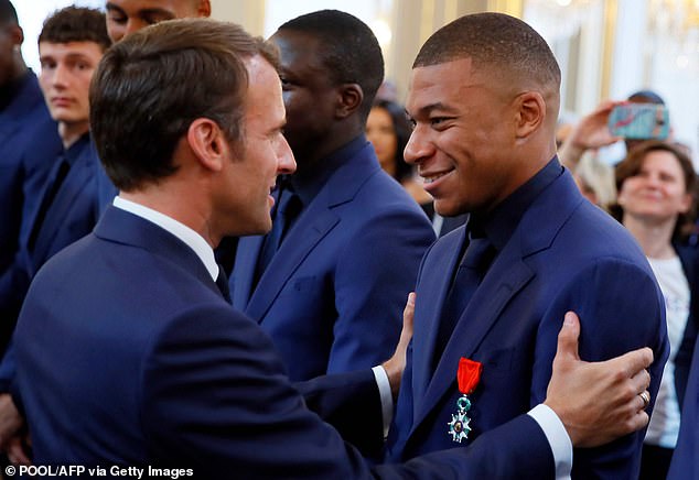 Kylian Mbappe (right) is a guest of French President Emmanuel Macron (left) on Tuesday.
