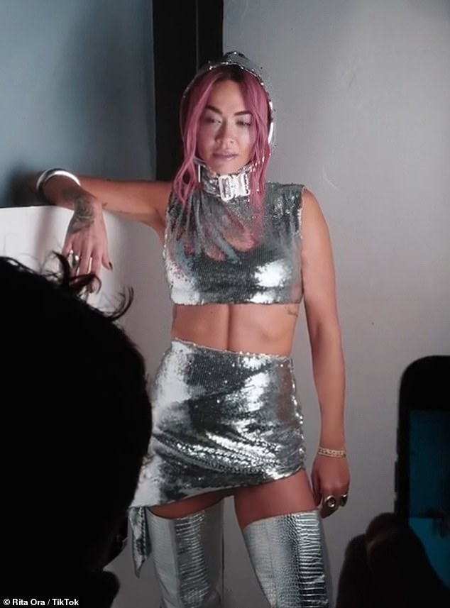 Rita Ora showed off her new long pink locks as she shared a TikTok video from behind the scenes of her new single Last Of Us on Thursday