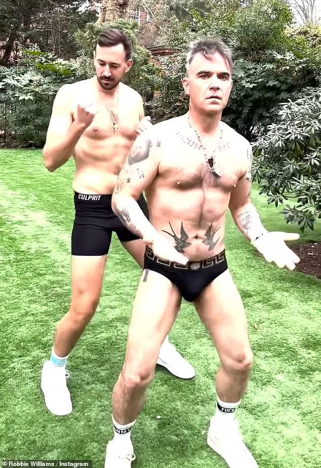 Robbie Williams, 49, left fans speechless when he stripped down to his underwear and donned a sexy red negligee for a seductive Valentine's Day Instagram post on Tuesday