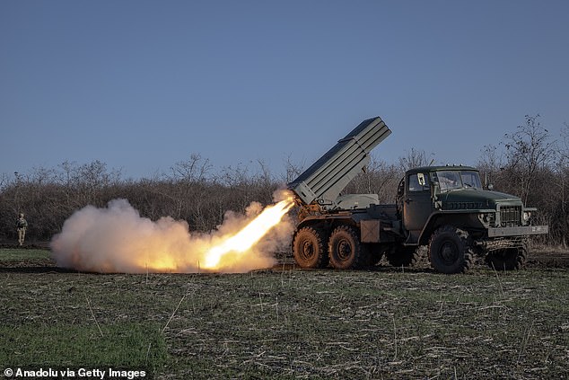 Ukrainian soldiers fire artillery at their fighting position towards Avdiivka in Donetsk Oblast