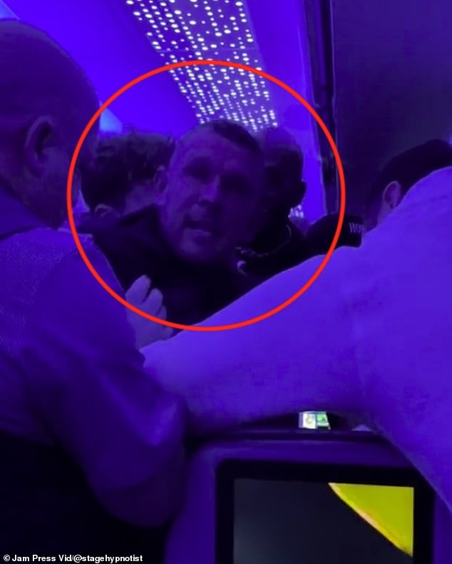 The video showed a group of Britons, who intervened to help airline staff calm the man (circled), and struggled to restrain him