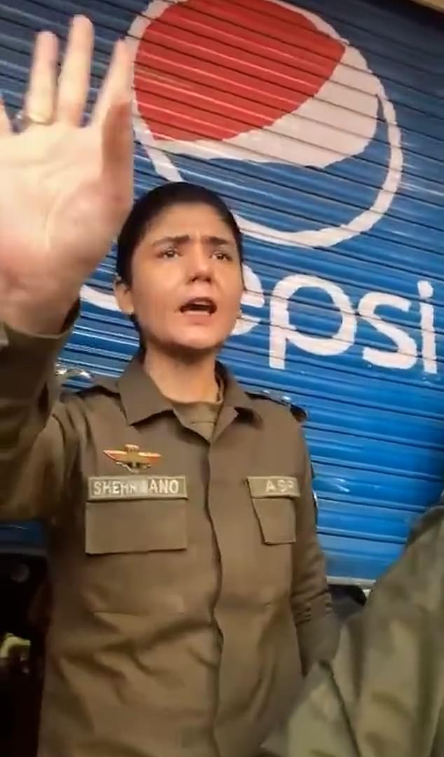 A brave female officer tries to reason with the men, asking them to 'have faith in the police' and not take the law into their own hands