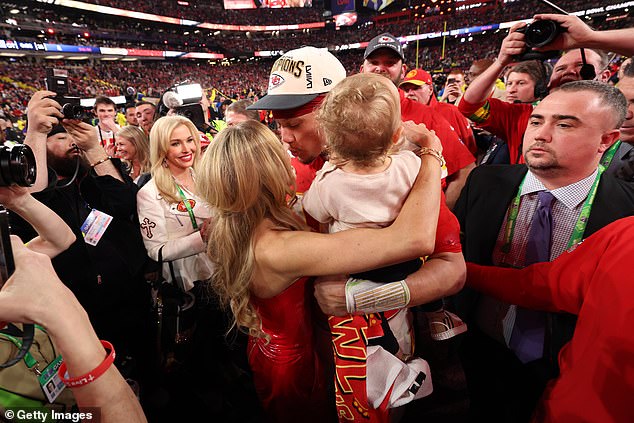 Brittany Mahomes, 28, shared a sweet kiss with husband Patrick Mahomes as she celebrated the Kansas City Chiefs' Super Bowl LVIII victory against the San Francisco 49ers on Sunday