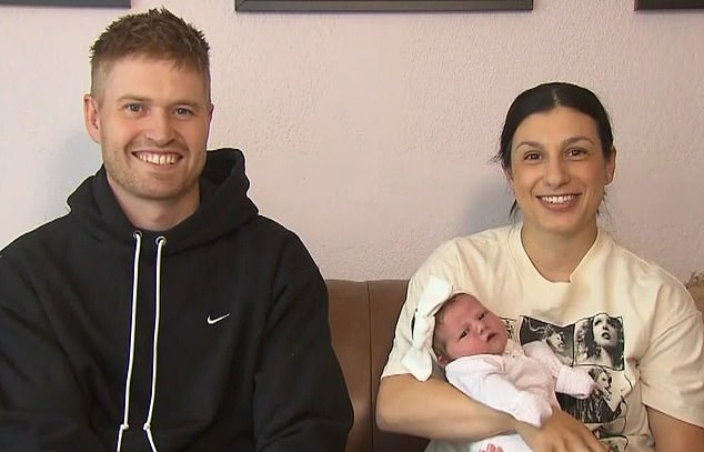 Tenille Smith (pictured right) appeared on Sunrise on Tuesday with husband Josh (pictured left) and said her new daughter - born just hours after the concert ended - is named Sloane Tayla Smith (pictured in her mother's arms)