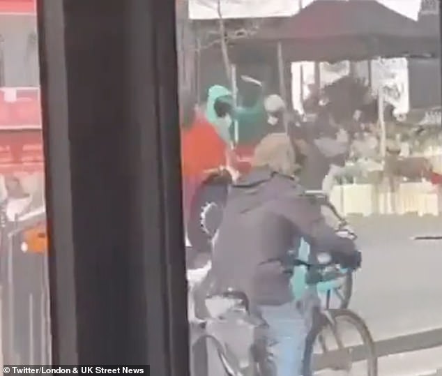 Three men were seen waving machetes at each other on a street in Stockwell, London, on Friday afternoon