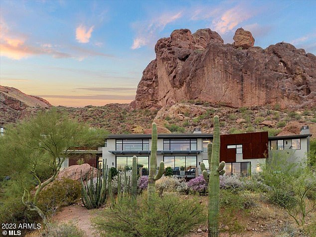 On the market for $8,888,888, this five-bedroom home is nestled among cacti and dramatic rock outcrops - designed to maximize views of Camelback and Mummy Mountains