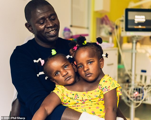 Ibrahima (pictured with his daughters a few years ago) had hoped that doctors at Great Ormond Street Hospital in London would be able to separate the girls, but tests showed that Marieme's heart was too weak for the operation and the doctors predicted that she would not survive the operation.  operation.  Ultimately it was decided not to separate the girls