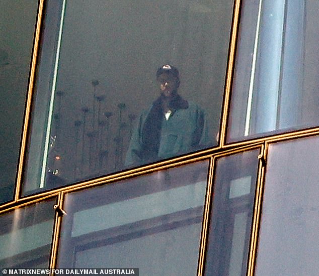 Travis Kelce was spotted admiring the view from his lavish Sydney hotel room after landing in Australia on Thursday morning