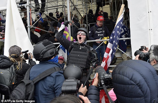 The 14th Amendment has been around since 1868, but the Supreme Court has never before considered Section 3, known as the Rebellion Clause.  Pictured: January 6 riot at the Capitol