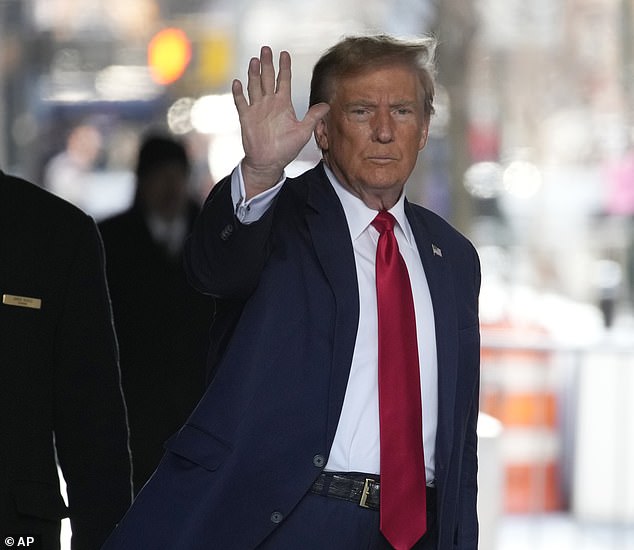 Former President Donald Trump waves as he leaves his Manhattan Trump Tower to appear in court Thursday as his lawyers try to get the Stormy Daniels hush money payment case thrown out — or at least postponed until after the election