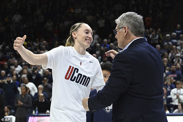 UConn's Paige Bueckers (5) reaches for coach Geno Auriemma during senior night ceremonies