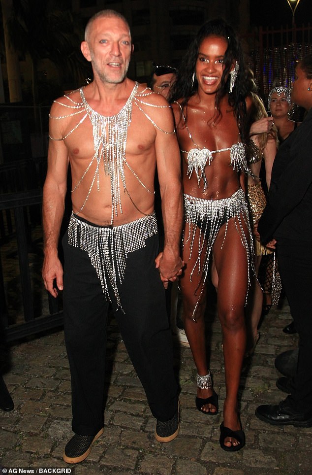 Vincent Cassel showed off his shirtless physique as he attended Rio Carnival with his scantily clad girlfriend Narah Baptista on Wednesday