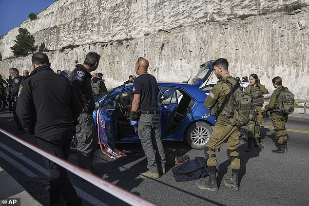 Israeli security forces investigate the scene of a shooting near the Maale Adumim settlement in the West Bank, Thursday, February 22, 2024